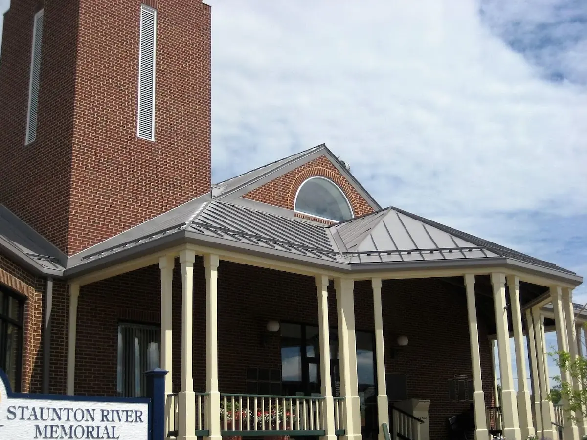 Skilled roofing craftsmen working on a residential roof in Whitesville